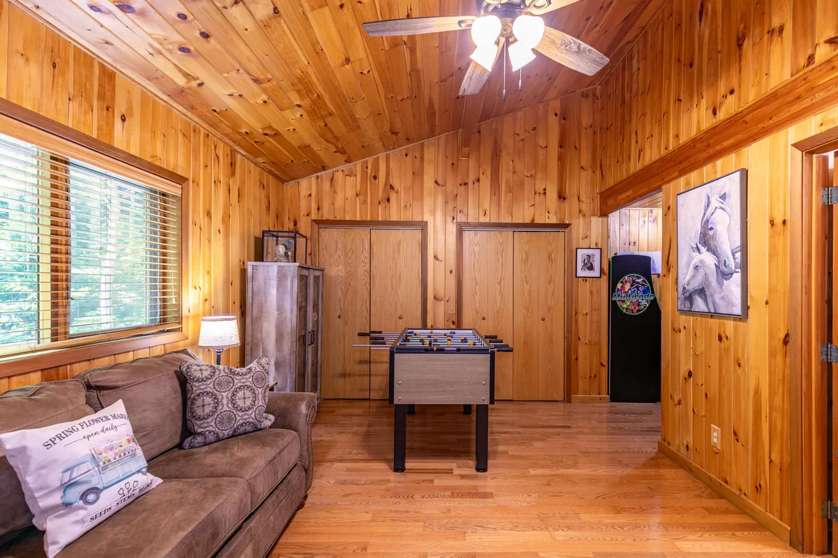 An inviting interior game room setup with a comfy sofa, foosball table, and playful artwork. The space is designed for laughter and togetherness, echoing the section's mention of indoor entertainment and memorable family game nights.